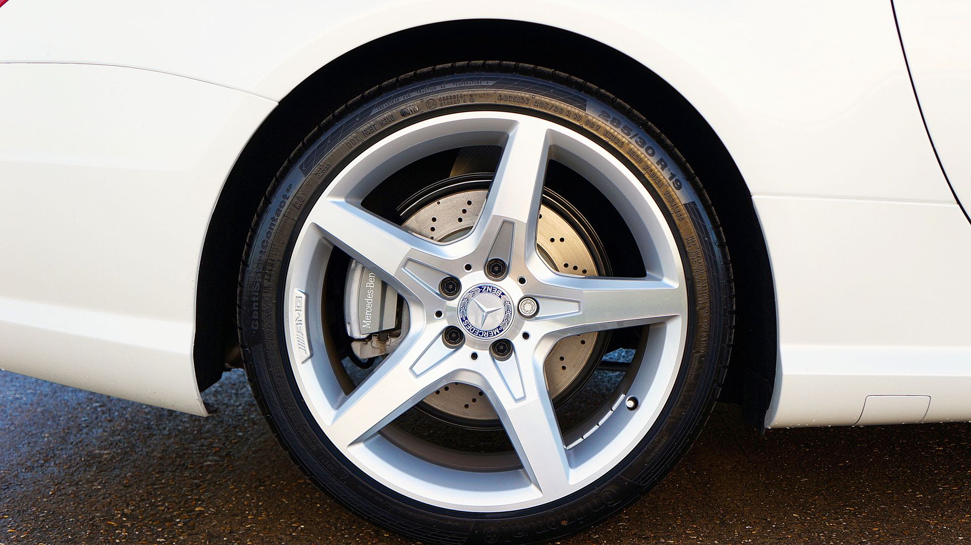 Detailed view of a Mercedes-Benz car wheel and rim featuring a five-spoke design.